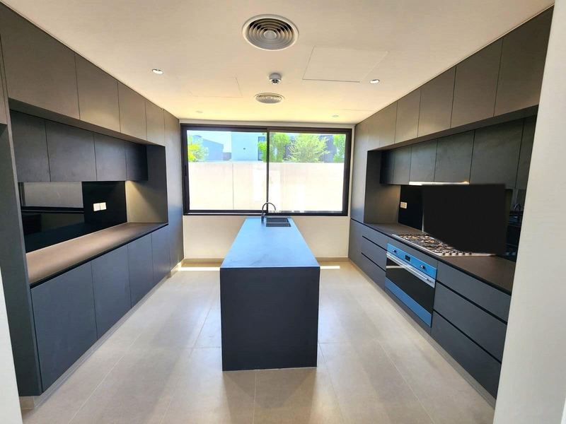 Island kitchen with dark cabinetry