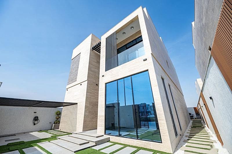 Villa elevation in stone and glass