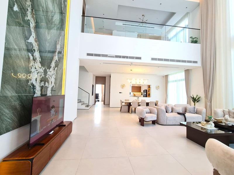 Double-height living room with feature stone wall
